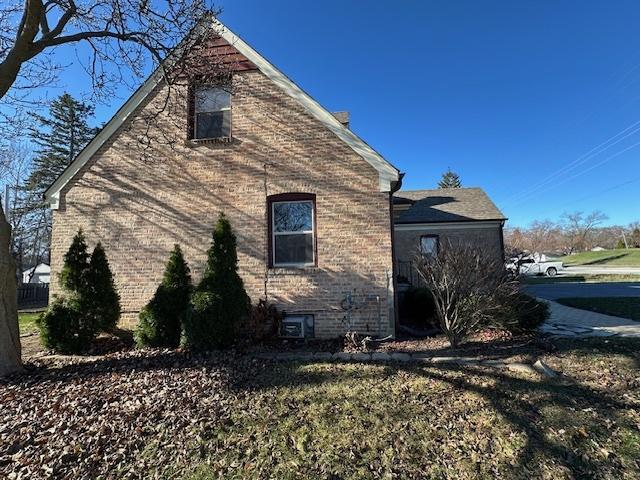 view of side of home with a lawn