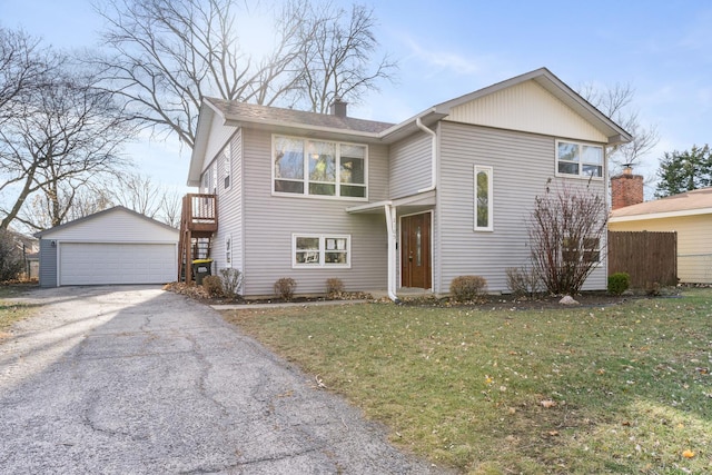 view of front of home with a front lawn, an outdoor structure, and a garage