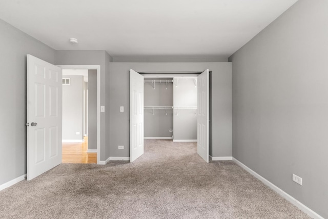 unfurnished bedroom featuring carpet and a closet