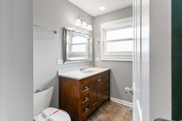 bathroom with tile patterned flooring, vanity, and toilet