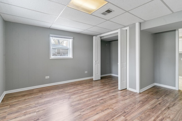 unfurnished bedroom featuring a paneled ceiling and light hardwood / wood-style floors