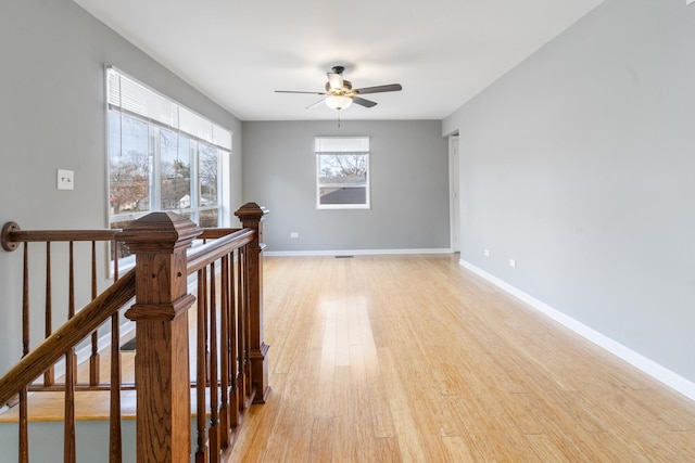 unfurnished room featuring ceiling fan and light hardwood / wood-style flooring