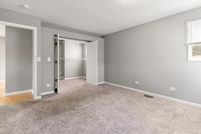 unfurnished bedroom with carpet and a closet