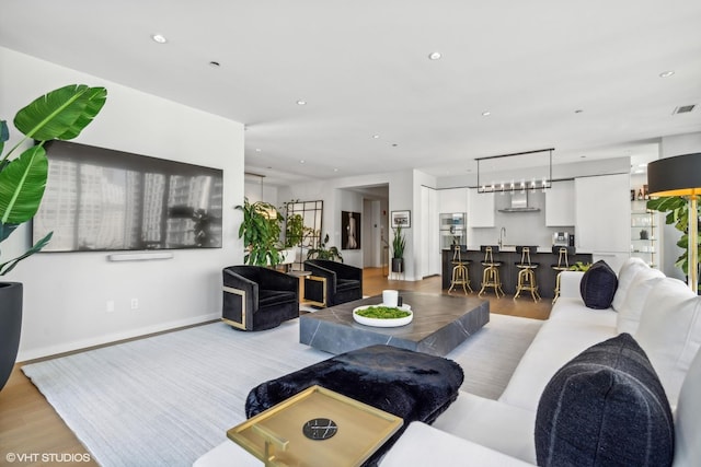 living room featuring light hardwood / wood-style flooring and sink