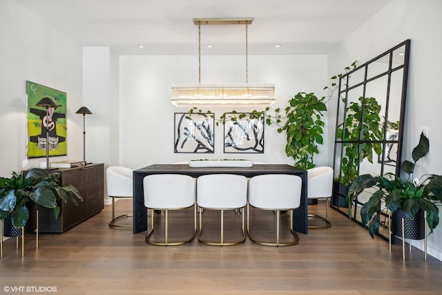 dining space with dark hardwood / wood-style flooring and a chandelier