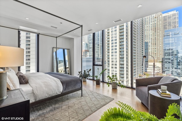 bedroom featuring hardwood / wood-style floors and floor to ceiling windows