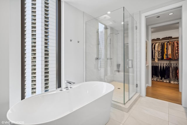 bathroom featuring tile patterned floors and shower with separate bathtub