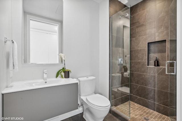 bathroom featuring walk in shower, vanity, and toilet