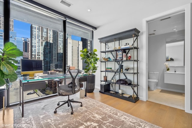 home office with wood-type flooring