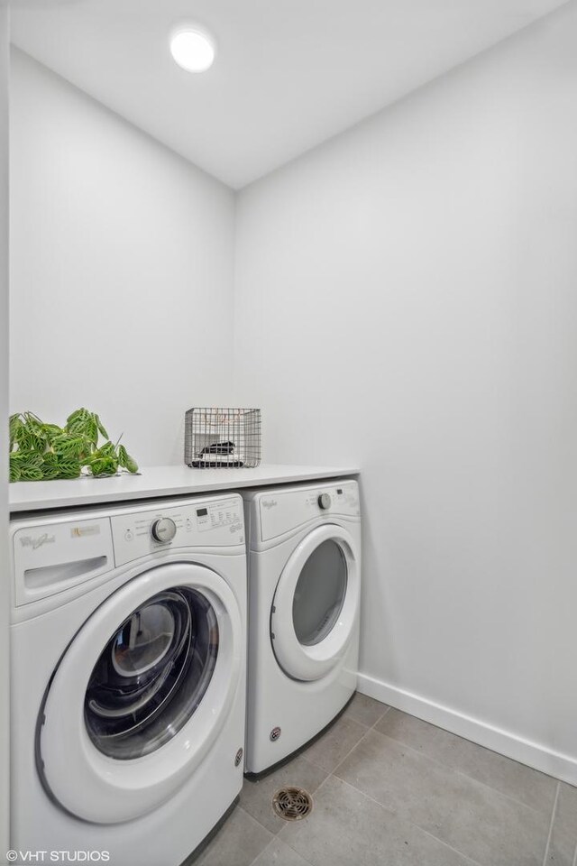 laundry area featuring independent washer and dryer and light tile patterned flooring