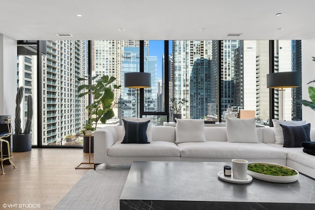 interior space featuring hardwood / wood-style floors, expansive windows, and a healthy amount of sunlight