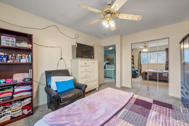 carpeted bedroom with ceiling fan and a closet