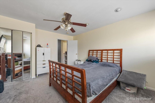 bedroom with carpet, a closet, and ceiling fan