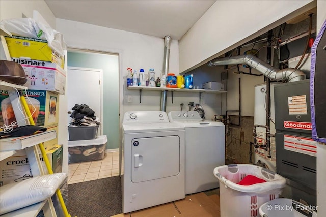 laundry room featuring gas water heater, light tile patterned floors, and washing machine and clothes dryer