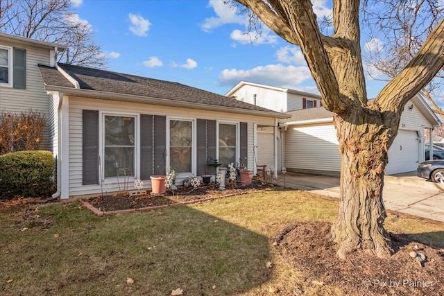 rear view of property with a yard and a garage