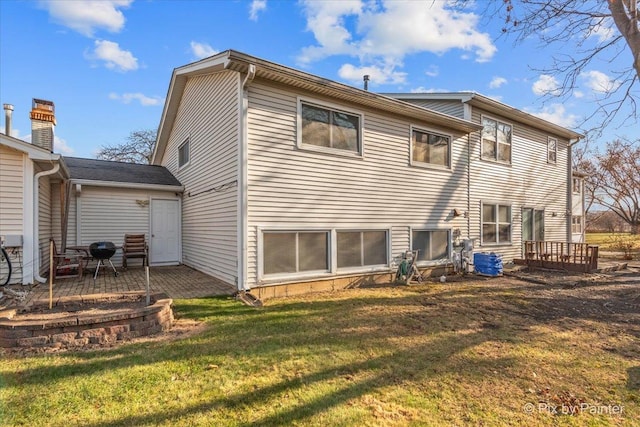 rear view of property with a yard