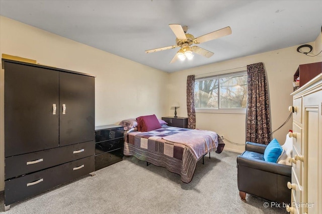 carpeted bedroom featuring a closet and ceiling fan