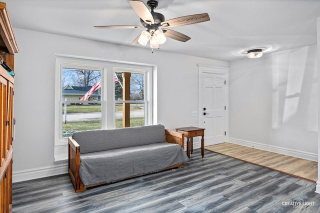 sitting room with ceiling fan and dark hardwood / wood-style flooring