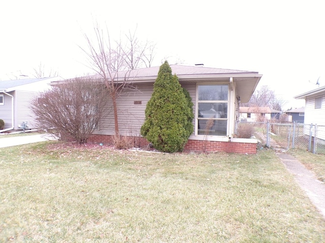 view of side of home with a yard