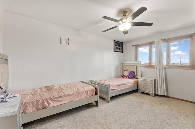 carpeted bedroom featuring ceiling fan