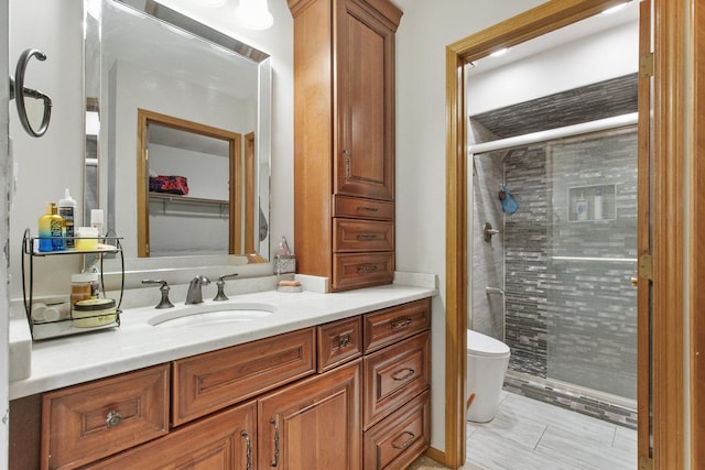 bathroom featuring vanity, toilet, and a shower with door