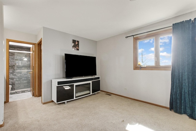 unfurnished living room featuring light carpet