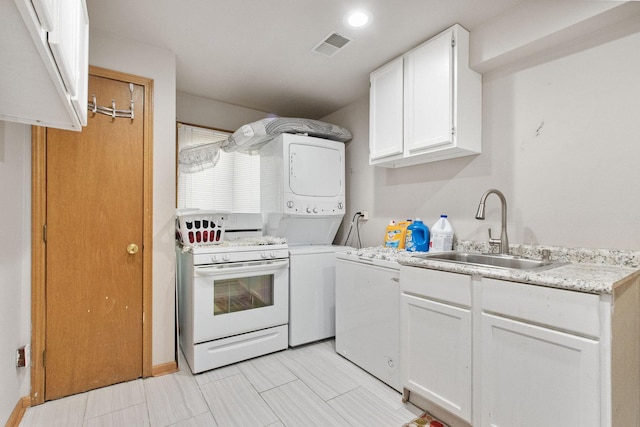 kitchen featuring white range oven, sink, white cabinets, and stacked washer and clothes dryer