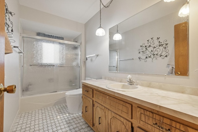 full bathroom featuring tile patterned flooring, vanity, toilet, and enclosed tub / shower combo