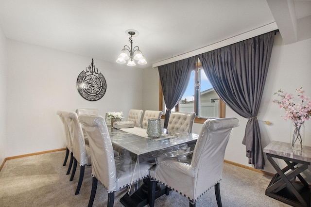 carpeted dining area with a notable chandelier