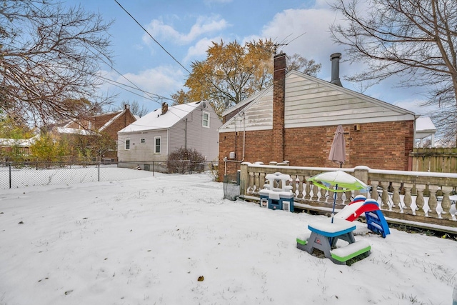 snow covered house featuring a deck