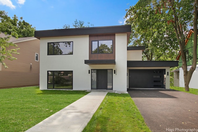 contemporary home featuring a front lawn and a garage