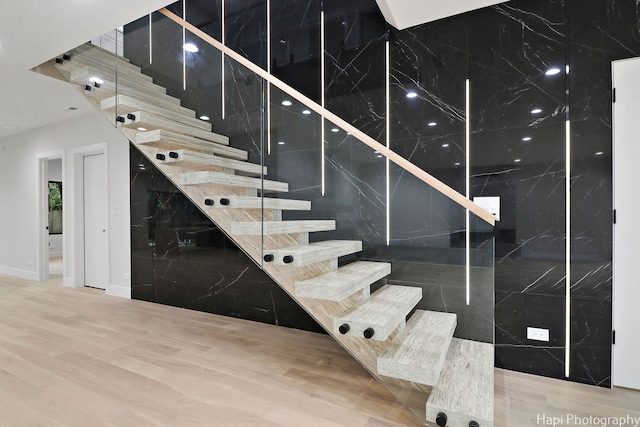 staircase featuring hardwood / wood-style flooring