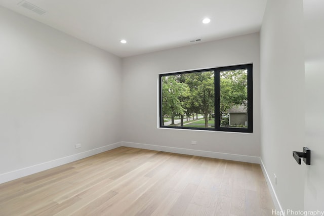 unfurnished room with light wood-type flooring