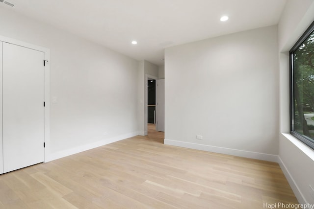 spare room with light hardwood / wood-style floors