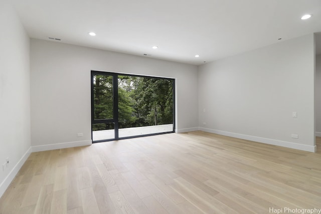 empty room with light hardwood / wood-style flooring