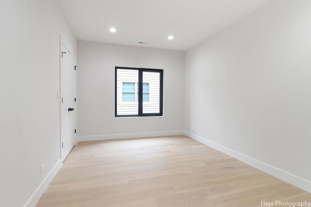 spare room with light hardwood / wood-style flooring