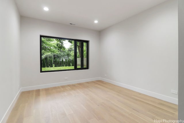 unfurnished room with light hardwood / wood-style floors