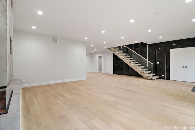 unfurnished living room with light hardwood / wood-style flooring