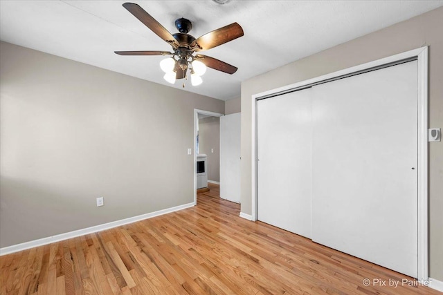 unfurnished bedroom with ceiling fan, light hardwood / wood-style floors, and a closet