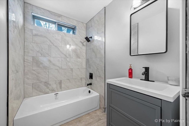 bathroom featuring vanity and tiled shower / bath combo