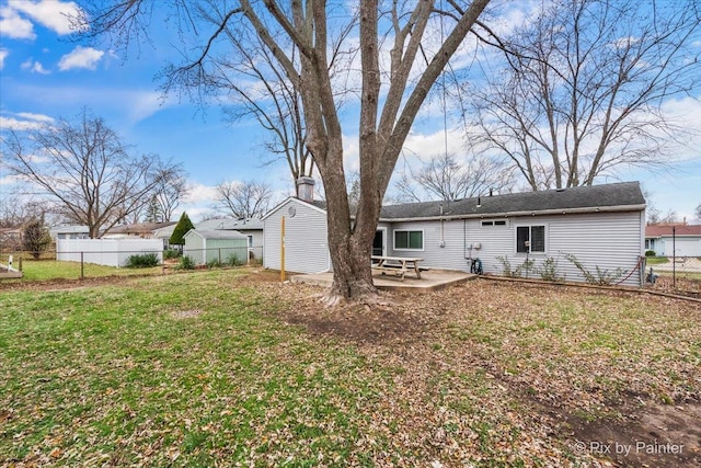 back of house with a lawn and a patio area