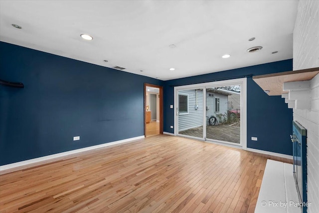 unfurnished living room with light hardwood / wood-style flooring