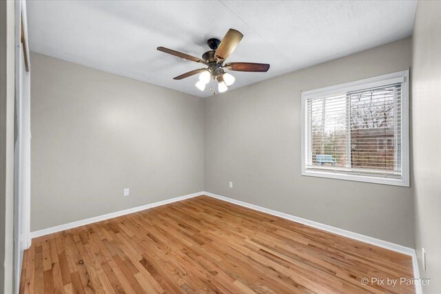 spare room featuring ceiling fan and light hardwood / wood-style flooring