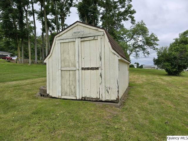 view of outbuilding with a lawn