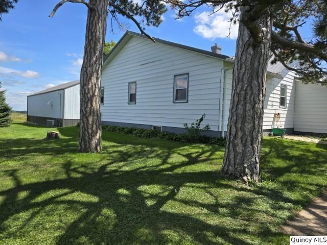 view of side of property featuring a yard