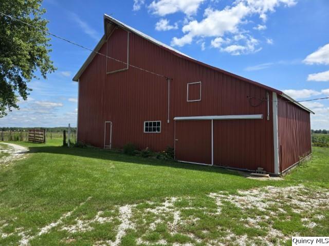 view of outbuilding with a yard