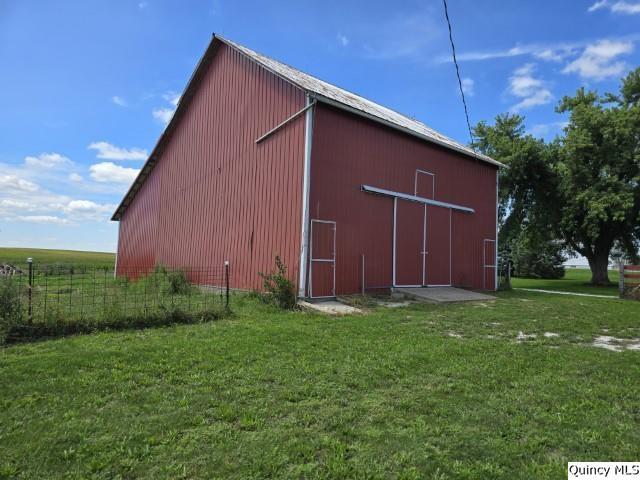 view of outbuilding with a yard