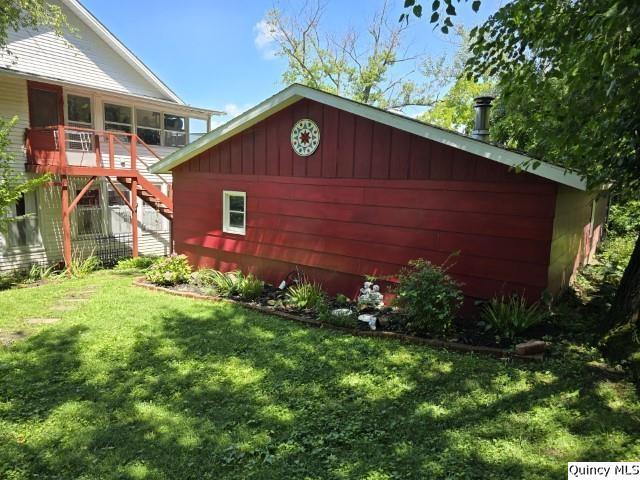 view of outbuilding with a lawn