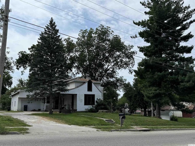 view of property with a garage and a front lawn