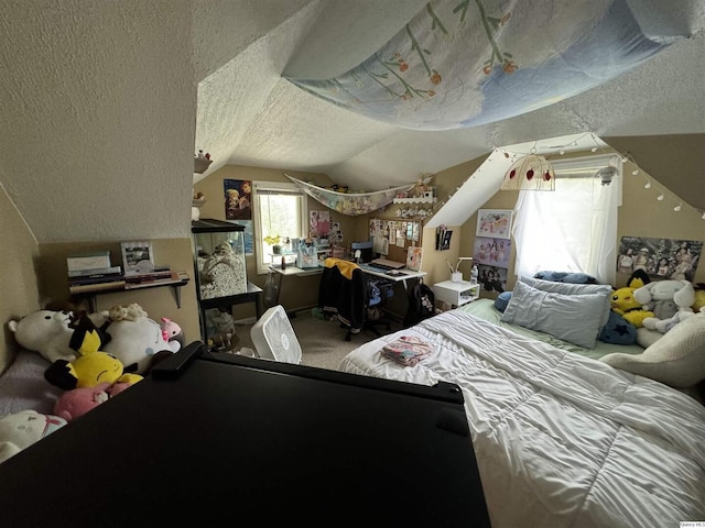 bedroom featuring vaulted ceiling, carpet, and a textured ceiling